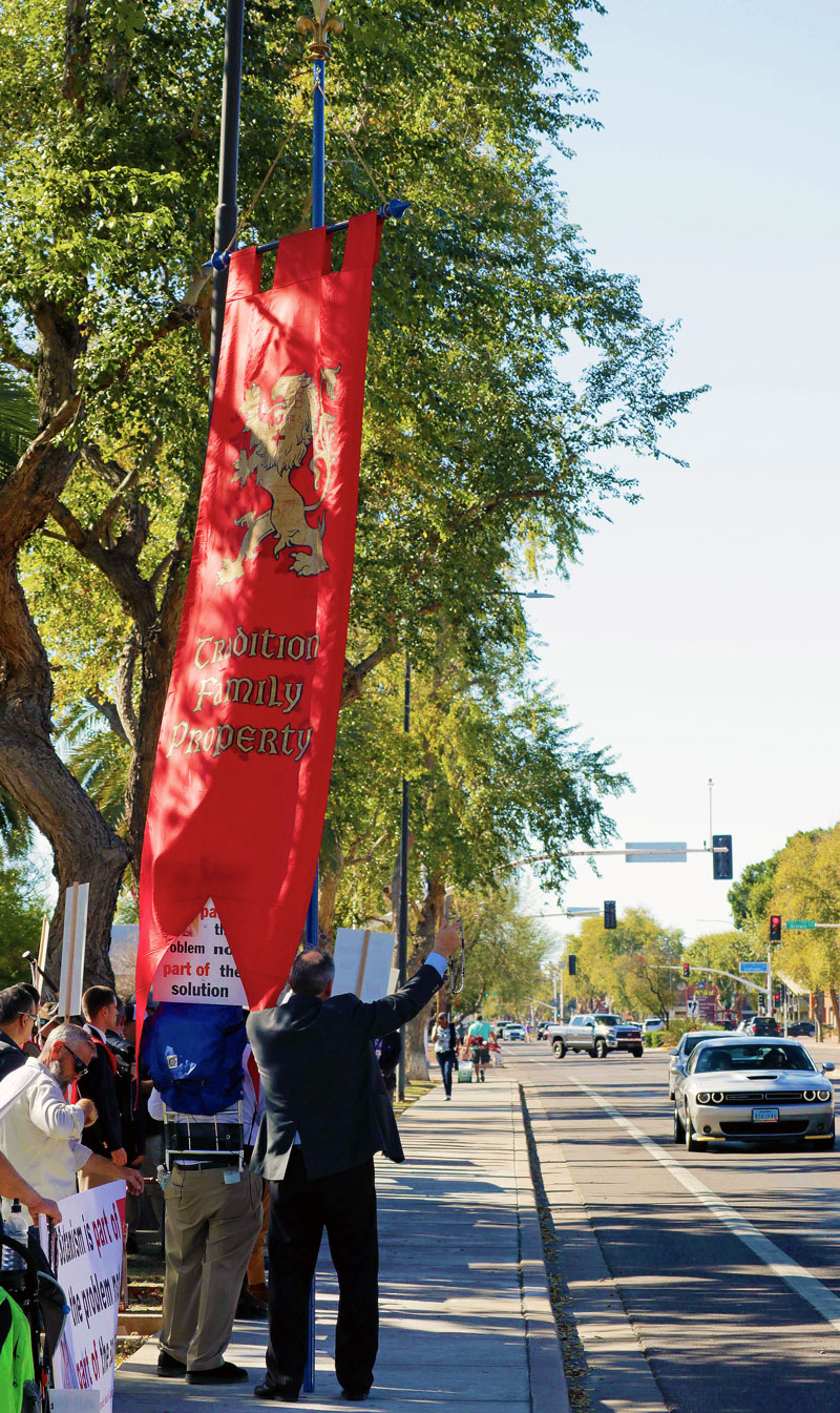 TFP supporter Leo Fitzsimmons holds the iconic red standard of the TFP. The “standard glowed red in the Arizona afternoon sun.”